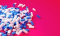 Capsule medicine pills, health pharmacy concept. Drugs for treatment medication. Heap of blue white color capsules on pink backgro Royalty Free Stock Photo