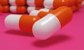 Capsule medicine pills, health pharmacy concept. Drugs for treatment medication. Heap of orange white color capsules on pink backg Royalty Free Stock Photo