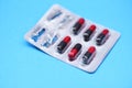 Capsule pill in blister pack - color red and black medicine pills capsule drugs concept