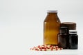 Capsule pills and amber bottles with cap Royalty Free Stock Photo