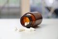 Capsule pills spill out brown bottles on blurry background. Royalty Free Stock Photo