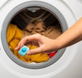 Capsule for softening water and preventing limescale in the washing machine. Royalty Free Stock Photo