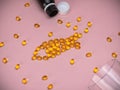 Capsules of cod liver oil arranged in a fish shape on pink background. Fish Shaped Fish Oil. Royalty Free Stock Photo