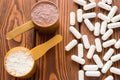 Capsules of creatine and protein measuring spoons