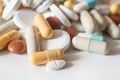 Capsules and drug tablets on white background