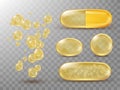 Capsules with oil, gold round and oval pills. Royalty Free Stock Photo