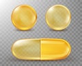 Capsules with oil, gold round and oval pills. Royalty Free Stock Photo