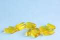 Capsules omega3, pills fish oil, cod-liver fat or flaxseed linseed oil on light blue background