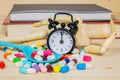 Capsules and pills on wood background