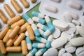 Capsules, pils and drug tablets on green background