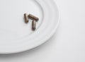 Capsules on white plate Royalty Free Stock Photo