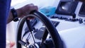 Captain behind the wheel of a luxury yacht. Stock. Closeup of the hands of men manoeuvre the yacht