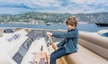 Captain boy drives the yacht. Travel adventure concept. Yachting with child on summer vacation.