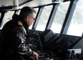 Captain on the bridge of a passenger ship `Via Australis` in the archipelago of Tierra del Fuego.