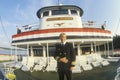 The captain of the Delta Queen, a relic of the steamboat era of the 19th century, stands on the forward deck of the boat