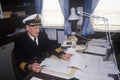 The captain of the ferry Bluenose doing paperwork at his desk, Maine