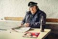 Captain of the ferry on mountain lake Hallstatt during break