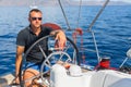 Captain at the helm controls of a sailing boat during sea yacht race. Sport. Royalty Free Stock Photo