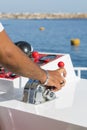 Captain at the helm yacht. Men`s hand drives a yacht. concept of sea recreation and tourism. vertical photo