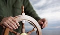 Captain holding hand on ship rudder. Royalty Free Stock Photo