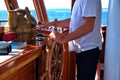 Captain holding hands on ship rudder Royalty Free Stock Photo