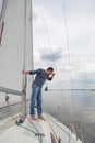 Man is sailing  yacht and looking through binoculars Royalty Free Stock Photo