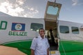 Captain of Maya Island Air Belize opens the door for passengers boarding his plane