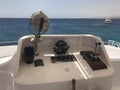 The captain`s cabin on a carboat, boat, cruise liner with a steering wheel, echo sounder, sea compass, navigator, gas grip, tacho