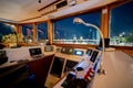 Captain`s cabin with steering wheel and navigation equipment