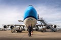 Captain standing in front of a big airplane. Pilot with the Boeing 747. Jumbo jet front view with captain. Royalty Free Stock Photo