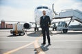 Captain standing while his plane preparing for flight Royalty Free Stock Photo