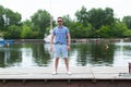 Captain in the tourist travel. Pending the ship at the pier. man in sunglasses pending the boat.