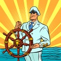 Captain in a white uniform at the helm of the ship Royalty Free Stock Photo