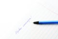 Caption ballpoint pen in a school notebook Royalty Free Stock Photo