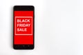 Caption BLACK FRIDAY SALE on smartphone screen. Concept of sales, online shopping, and e-commerce.