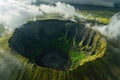 Captivating aerial view showcasing a crater enveloped by a stunning cloud formation, creating a mesmerizing natural landscape, A Royalty Free Stock Photo