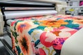Floral printed fabric is emerging from a wide format inkjet printer machine now Royalty Free Stock Photo