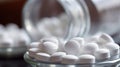 Close up of white pills spilling out of pill bottle on blurred background Royalty Free Stock Photo