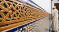Exquisite Moroccan architectural details with intricate geometric tilework and a cultural figure Royalty Free Stock Photo