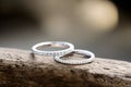 Captivating close up shot of two wedding rings, delicately intertwined to symbolize the everlasting bond of love and commitment.