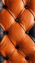 Captivating close-up view of a rich, orange-toned leather surface with intricate diamond-shaped tufts and dark buttons Royalty Free Stock Photo