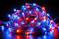 Captivating Coiled Red and Blue LED String Lights A Study in Artistic Illumination on a Black Background Royalty Free Stock Photo