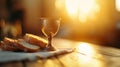 Close up shot of ancient Passover bread and wine in antique cup illuminated by golden hour light Royalty Free Stock Photo