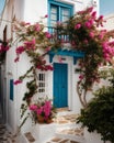 Captivating Greek House with White Walls, Blue Accents, and Blooming Pink Flowers