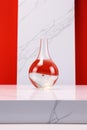 Crystal Clear Jeopardy: Suspended Red Liquid on Marble Table