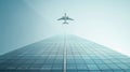airplane soaring above a sleek, triangular glass skyscraper.
