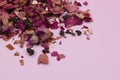 Dried rose petals on a pink background, purple rose flowers close-up, romantic floral texture Royalty Free Stock Photo