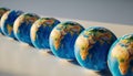 Row of Miniature Earth Globes on White Background Royalty Free Stock Photo