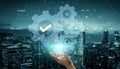 Futuristic digital interface depicting a hand interacting with virtual gears and icons representing technology, security Royalty Free Stock Photo
