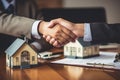 Real estate agent shaking hands with customer after signing contract to buy house. Ai generative Royalty Free Stock Photo